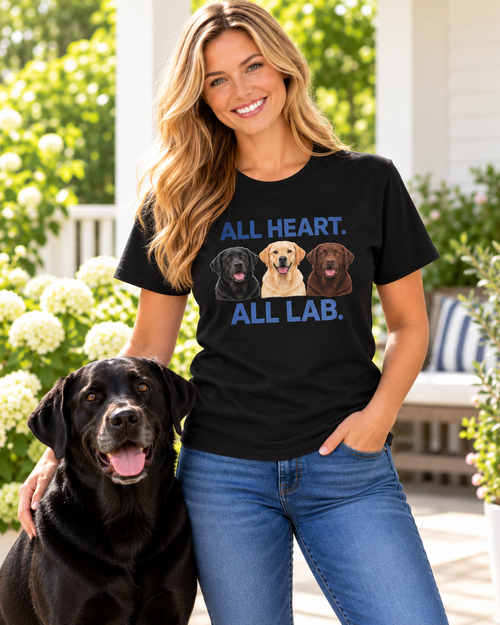 Same blonde model wearing the black All Heart All Lab T-shirt with a black Labrador